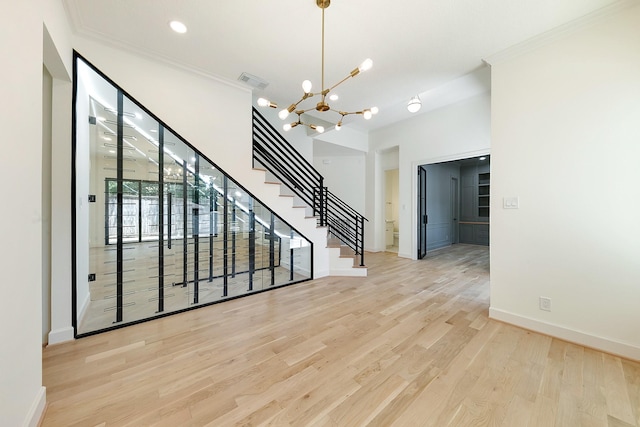 4528 S Evergreen St, Bellaire, TX 77401 - empty room with a chandelier, ornamental molding, wood finished floors, baseboards, and stairway