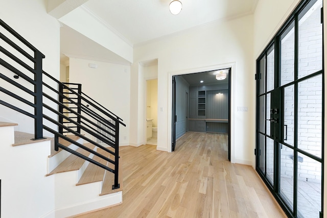 4528 S Evergreen St, Bellaire, TX 77401 - stairs with crown molding, wood finished floors, and baseboards
