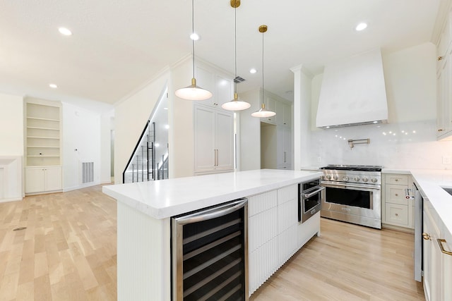 4528 S Evergreen St, Bellaire, TX 77401 - kitchen featuring wine cooler, stainless steel appliances, custom range hood, a kitchen island, and white cabinets