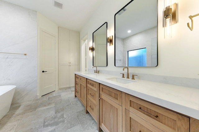 4528 S Evergreen St, Bellaire, TX 77401 - bathroom with double vanity, a soaking tub, and stone finish flooring