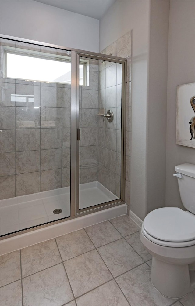 1472 Sundown Gln, Katy, TX 77493 - full bathroom featuring toilet, a shower stall, tile patterned flooring, and baseboards