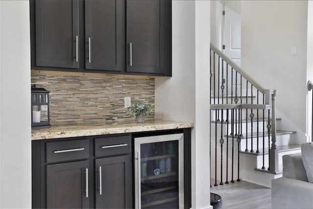 4104 Marina St, Houston, TX 77007 - indoor dry bar with wine cooler, backsplash, wood finished floors, and stairway