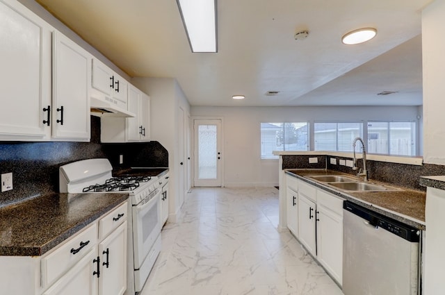 19603 Green Chase Ln, Houston, TX 77073 - kitchen featuring dishwasher, white gas range oven, under cabinet range hood, light marble finish flooring, and dark countertops