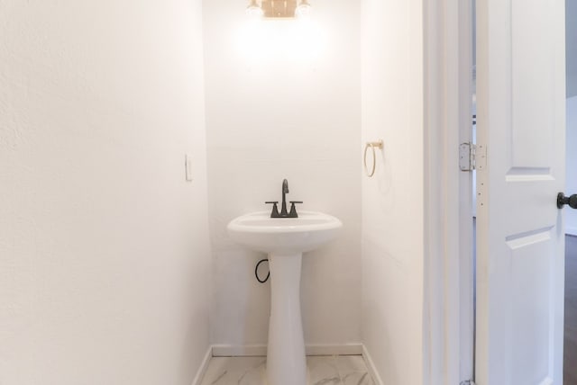 19603 Green Chase Ln, Houston, TX 77073 - bathroom with marble look tiles and baseboards