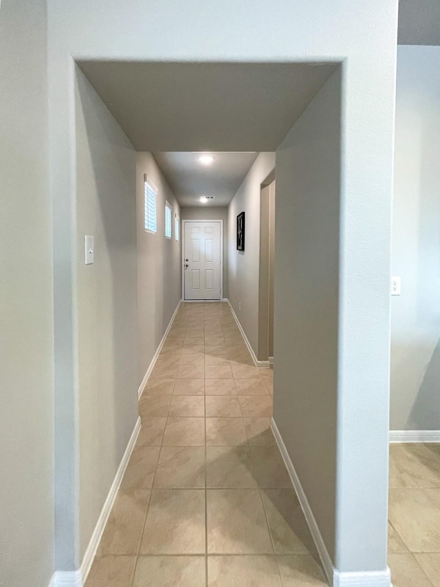 17807 Cappadocia Trl, Tomball, TX 77377 - hallway featuring light tile patterned floors and baseboards