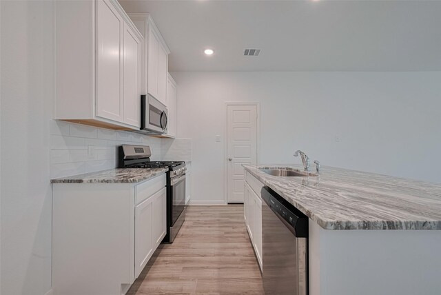 17807 Cappadocia Trl, Tomball, TX 77377 - kitchen featuring stainless steel appliances, light wood-style floors, white cabinets, and recessed lighting