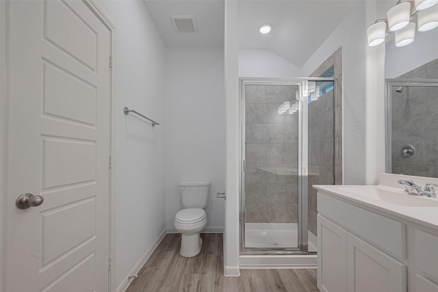 17807 Cappadocia Trl, Tomball, TX 77377 - full bathroom featuring vanity, wood finished floors, a shower stall, and vaulted ceiling