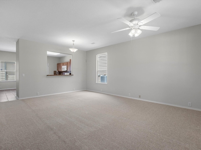 23807 Township Elm St, Spring, TX 77373 - empty room featuring light carpet, baseboards, and a ceiling fan