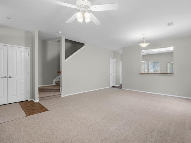 23807 Township Elm St, Spring, TX 77373 - unfurnished living room with carpet flooring, a ceiling fan, stairway, and baseboards