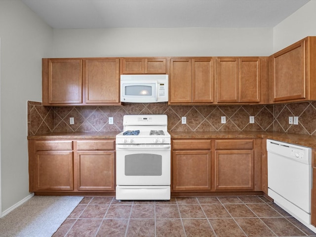 23807 Township Elm St, Spring, TX 77373 - kitchen featuring white appliances, decorative backsplash, and brown cabinets