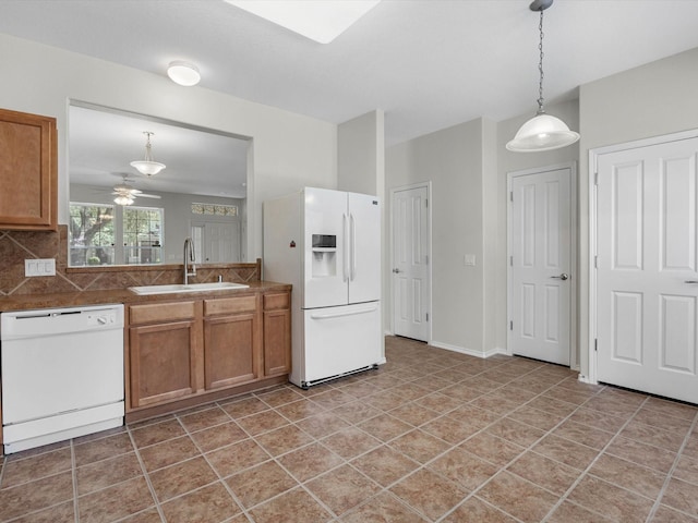 23807 Township Elm St, Spring, TX 77373 - kitchen featuring white appliances, a sink, brown cabinetry, a ceiling fan, and decorative light fixtures