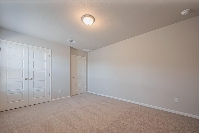 22807 Ephesus Ave, Tomball, TX 77377 - unfurnished bedroom with light carpet, baseboards, and a closet