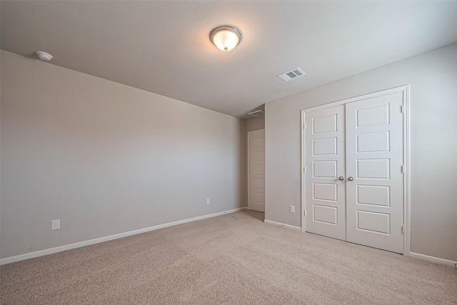 22807 Ephesus Ave, Tomball, TX 77377 - unfurnished bedroom with light carpet, baseboards, and a closet