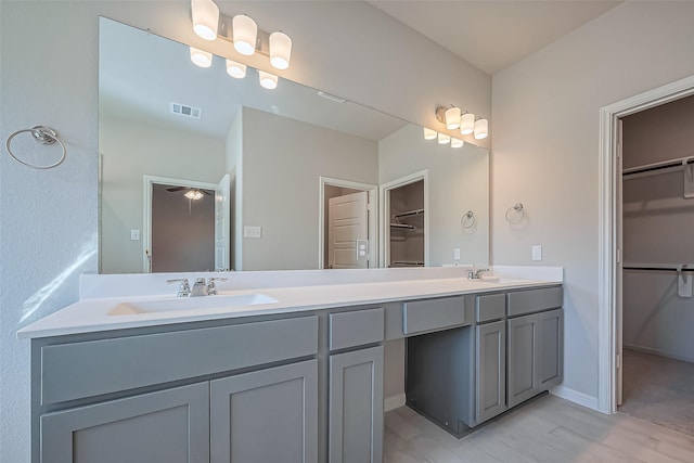 22807 Ephesus Ave, Tomball, TX 77377 - bathroom with double vanity, a spacious closet, and wood finished floors