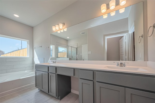 22807 Ephesus Ave, Tomball, TX 77377 - full bath featuring a stall shower, double vanity, a garden tub, and wood finished floors