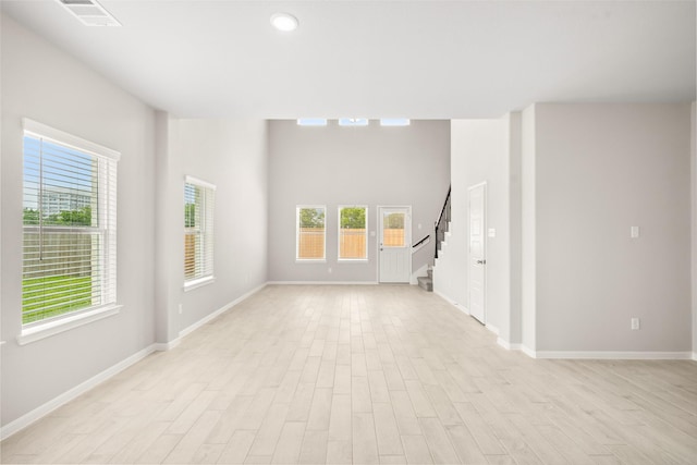 3211 Falling Brook Dr, Baytown, TX 77521 - unfurnished room featuring stairway, baseboards, light wood finished floors, and recessed lighting