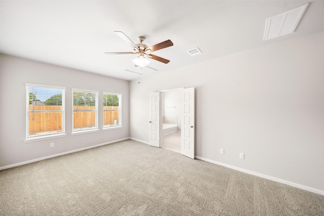 3211 Falling Brook Dr, Baytown, TX 77521 - unfurnished bedroom featuring carpet, baseboards, ensuite bath, attic access, and a ceiling fan