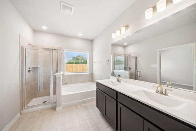 3211 Falling Brook Dr, Baytown, TX 77521 - full bath with a shower stall, a bath, double vanity, wood finished floors, and recessed lighting