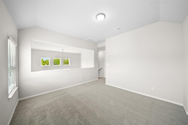 3211 Falling Brook Dr, Baytown, TX 77521 - carpeted spare room with lofted ceiling and baseboards
