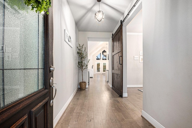 3423 Crescent Vista Dr, Fulshear, TX 77441 - entryway with a barn door, baseboards, and light wood-style floors