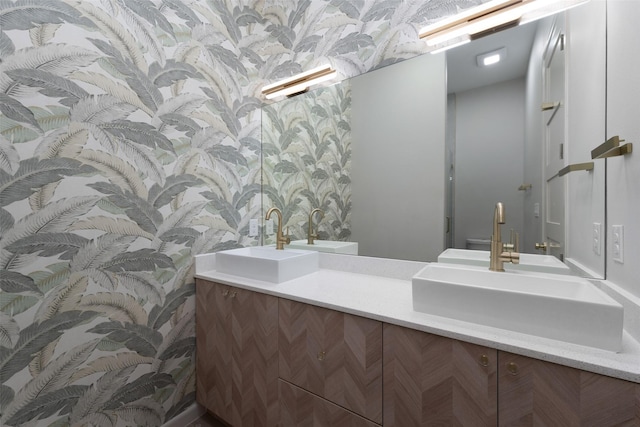5606 Circe Cir Unit A, South Padre Island, TX 78597 - bathroom with double vanity and wallpapered walls