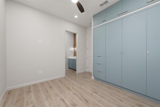 5606 Circe Cir Unit A, South Padre Island, TX 78597 - unfurnished bedroom featuring light wood finished floors, baseboards, recessed lighting, a closet, and ensuite bathroom