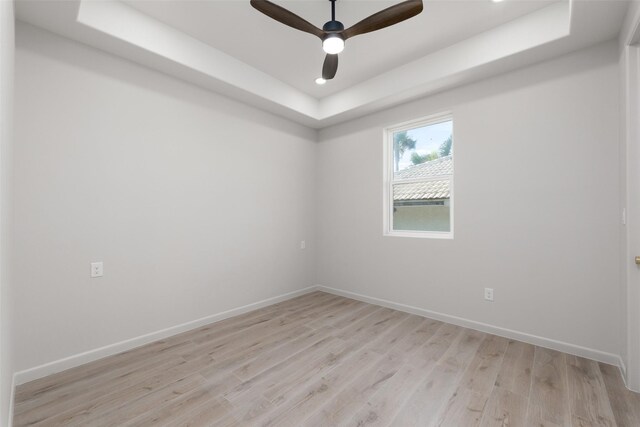 5606 Circe Cir Unit A, South Padre Island, TX 78597 - empty room featuring a tray ceiling, light wood finished floors, baseboards, a ceiling fan, and recessed lighting