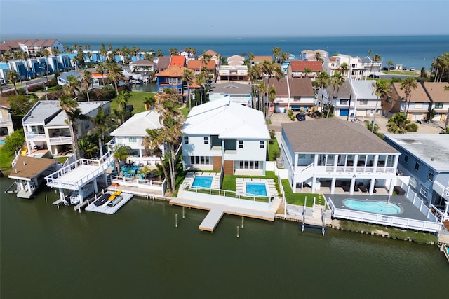 5606 Circe Cir Unit A, South Padre Island, TX 78597 - aerial perspective of suburban area with a large body of water and a pool