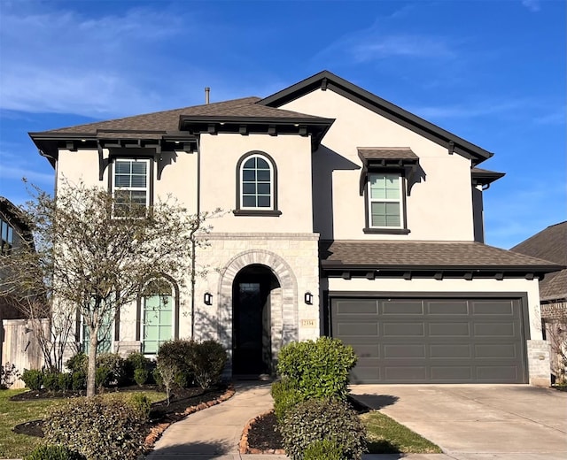 2334 Calm Channel Ct, Missouri City, TX 77459 - view of front of house with a shingled roof, stucco siding, driveway, an attached garage, and stone siding
