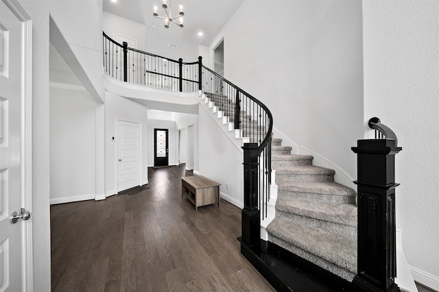 2334 Calm Channel Ct, Missouri City, TX 77459 - foyer entrance featuring stairway, a chandelier, dark wood finished floors, baseboards, and a towering ceiling