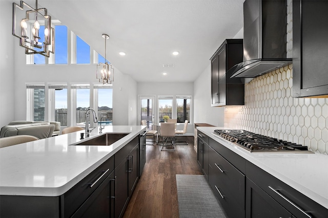 2334 Calm Channel Ct, Missouri City, TX 77459 - kitchen featuring a sink, a chandelier, stainless steel appliances, wall chimney exhaust hood, and dark wood-type flooring