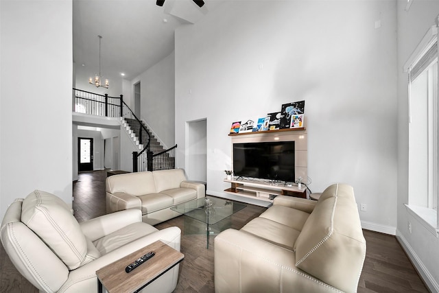 2334 Calm Channel Ct, Missouri City, TX 77459 - living area featuring a towering ceiling, wood finished floors, a chandelier, a ceiling fan, and stairway