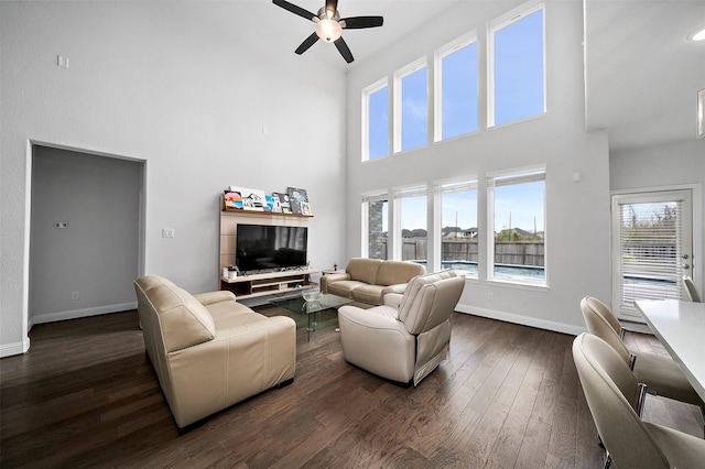 2334 Calm Channel Ct, Missouri City, TX 77459 - living room with a towering ceiling, a ceiling fan, baseboards, and dark wood-type flooring