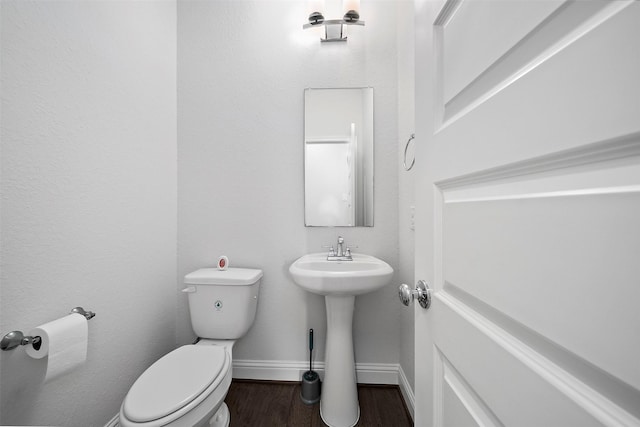 2334 Calm Channel Ct, Missouri City, TX 77459 - bathroom with toilet, wood finished floors, baseboards, and a sink