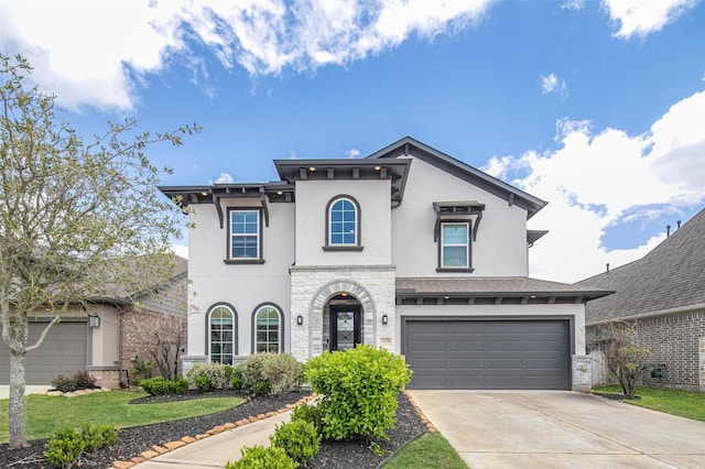 2334 Calm Channel Ct, Missouri City, TX 77459 - view of front of home featuring stucco siding, concrete driveway, a garage, and stone siding
