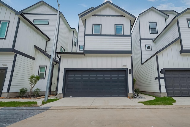 8927 Grovner Pl, Houston, TX 77055 - view of front of home featuring board and batten siding, an attached garage, and driveway