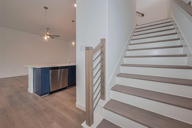 8933 Grovner Pl, Houston, TX 77055 - stairway with wood finished floors, ceiling fan, and a towering ceiling