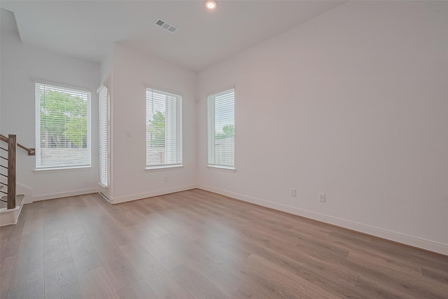 8933 Grovner Pl, Houston, TX 77055 - unfurnished room with stairs, light wood-style flooring, baseboards, and recessed lighting