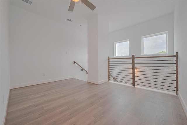 8933 Grovner Pl, Houston, TX 77055 - spare room with light wood-type flooring, a ceiling fan, and baseboards