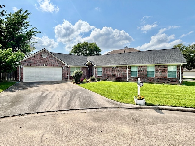 906 Juniper Ct, Tomball, TX 77375 - ranch-style house with a front yard, brick siding, concrete driveway, and a garage