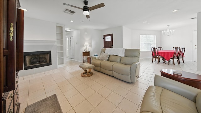 906 Juniper Ct, Tomball, TX 77375 - living room with built in features, a chandelier, light tile patterned floors, ceiling fan, and recessed lighting