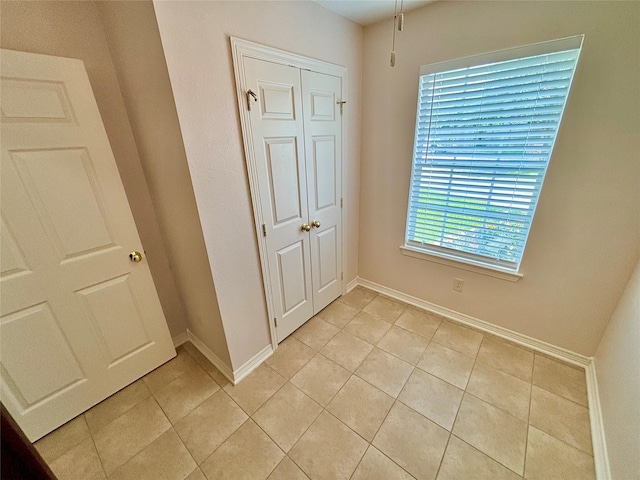 906 Juniper Ct, Tomball, TX 77375 - unfurnished bedroom with light tile patterned floors and baseboards