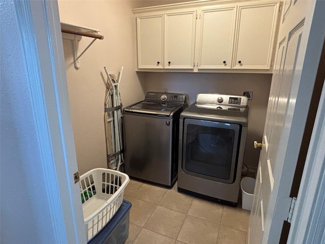 906 Juniper Ct, Tomball, TX 77375 - laundry room with cabinet space, washing machine and clothes dryer, and light tile patterned floors