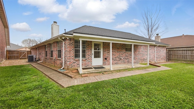 906 Juniper Ct, Tomball, TX 77375 - back of property featuring cooling unit, a patio area, brick siding, and a chimney
