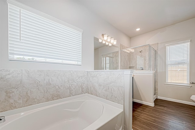 10155 Red Snapper Rd, Magnolia, TX 77354 - bathroom with a garden tub, a shower stall, wood finished floors, toilet, and baseboards