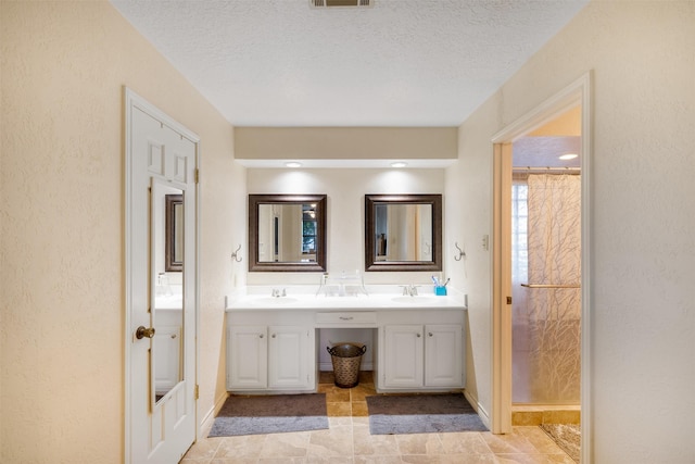 90 Fishermans Bend Dr, Point Blank, TX 77364 - full bathroom featuring baseboards, double vanity, a textured ceiling, tile patterned flooring, and a textured wall