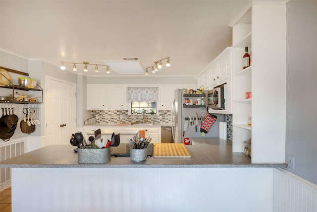 90 Fishermans Bend Dr, Point Blank, TX 77364 - kitchen featuring open shelves, freestanding refrigerator, stainless steel microwave, backsplash, and a peninsula