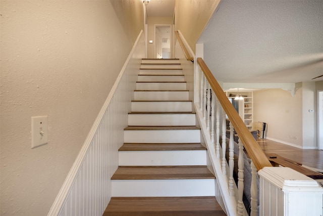 90 Fishermans Bend Dr, Point Blank, TX 77364 - stairway featuring a textured ceiling and wood finished floors