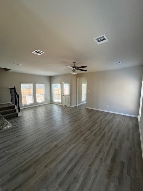 27290 Axis Deer Trl, Magnolia, TX 77354 - unfurnished living room featuring stairs, baseboards, dark wood finished floors, and ceiling fan