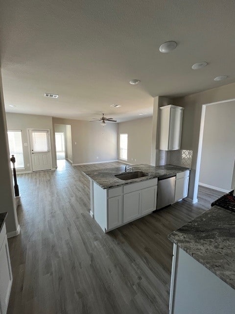 27290 Axis Deer Trl, Magnolia, TX 77354 - kitchen featuring stainless steel dishwasher, a sink, dark wood-type flooring, and white cabinets